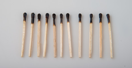 Burnt matches in a row on a white background