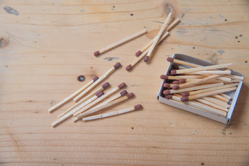 Matchboxes in a box and scattered around it on a wooden background. macro