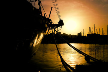 Silhouette of a sailing ship in the sunset. A ship in her home port.