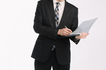 business document. business man, writing on a tablet on a blank sheet. A businessman in a businessman's suit signs a document on a white background.