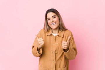 Young caucasian woman isolated raising both thumbs up, smiling and confident.