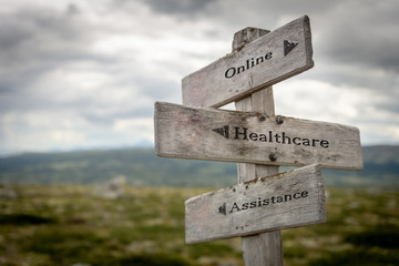 online, healthcare and assistance text on wooden road sign outdoors in nature.