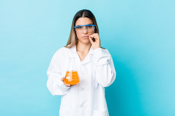 Young scientific woman with fingers on lips keeping a secret.