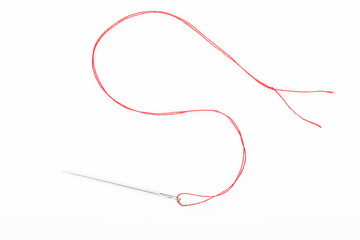 Sewing needle with red thread on the white background	 - obrazy, fototapety, plakaty