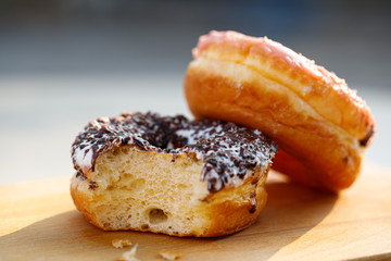 Chocolate donuts and missing bite closeup