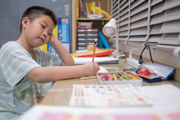 boy doing homework, kid writing paper