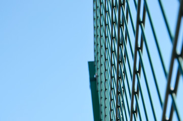 Metal fence against the blue sky in Close-up. Fence . Background.