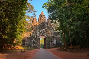 Ancient Cambodian face tower over the northern entrance gate of Angkor Thom city, surrounding Angkor Wat temple complex, in Siem Reap, Cambodia.