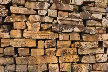 Archeological ruins at Bayon temple, located in Angkor, Cambodia, the ancient capital of the Khmer empire. Detail of the ancient sandstone blocks.