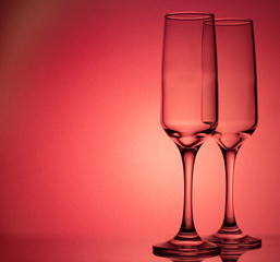 champagne glasses on a red background