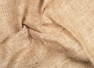 Brown burlap textile, close up view. Crumpled burlap fabric, abstract background. Texture of burlap linen