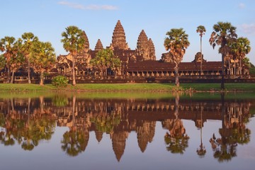 Fototapeta na wymiar Angkor Wat, in Cambodia. Front general view of western facade at sunset with reflections. Angkor Wat is the largest religious monument in the world, and has been declared UNESCO World Heritage Site