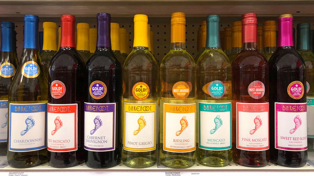 Alameda, CA - January 17, 2018: Grocery store shelf with bottles of Barefoot brand red and white wines. Barefoot Wine is a brand of wine produced by Barefoot Cellars which is based in Modesto, CA.