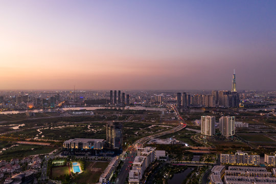 Aerial view to new luxury real estate developments along the Saigon river from Thu Thiem district, in Ho Chi Minh City, Vietnam at twilight