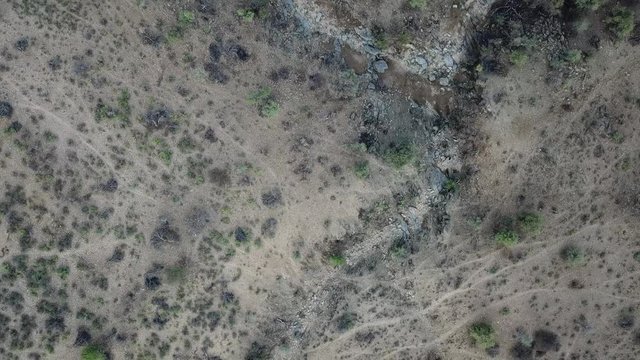 4K aerial drone summer day video African savanna and dry riverbeds surrounded by bush covered hills in Daan Viljoen National Game Park in Khomas Hochland area near Windhoek, Namibia's capital, Africa