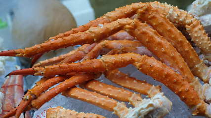 Close up big giant King crab legs on iced selling in japan market , food and travel concept.