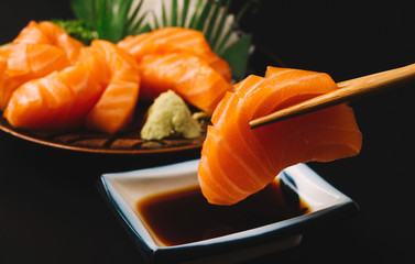 Sashimi, Salmon, Japanese food chopsticks and wasabi on the wood table - obrazy, fototapety, plakaty