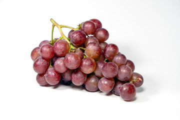 Purple grapes on white background..
