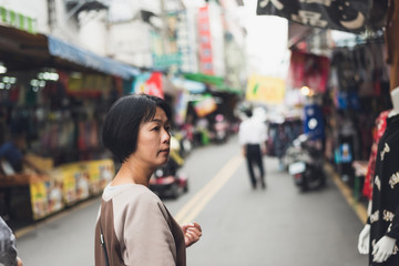Asian woman walking on the street