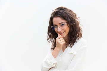 Beautiful smiling young woman holding hand near chin. Cheerful curly lady looking at camera. Female beauty concept