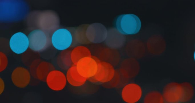 Car light blurred bokeh traffic on the road at night in a big city. 4k DCI 4096x2160.