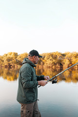 A man is fishing on the river. Fisherman on a morning fishing trip