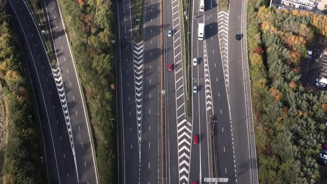 Helicopter police-chase style, bird's eye view of a busy motorway, following a high speed red car overtaking other cars | Edinburgh, Scotland | 4K at 30fps