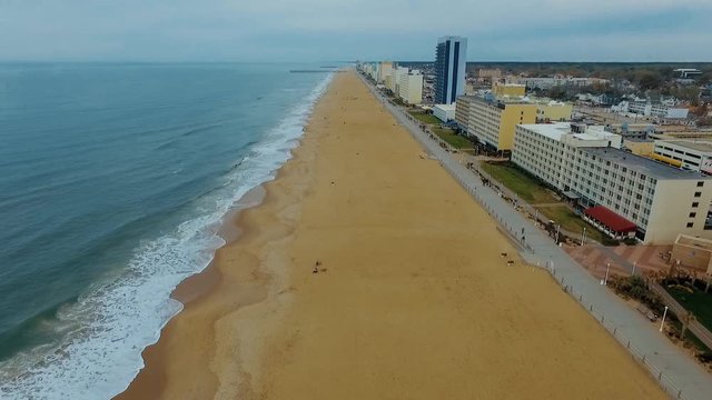 Drone, Aerial flyover of beach and boardwalk on overcast day in Virginia Beach