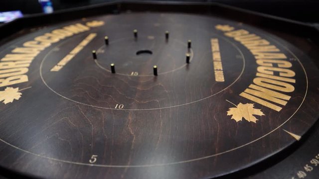 Close up view of playing Crokinole family board game