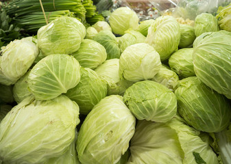 Fresh green cabbage on the market stall selling vegetables