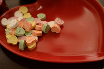 Valentines hearts, candy, and flowers. Motion blur movements and flowers on a vase.