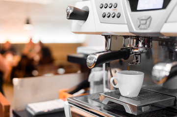 black coffee in white cup on coffee maker