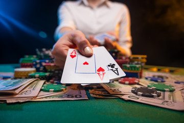 The dealer or player opens winning cards, two aces. A lot of money, chips, a casino and online...