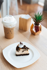 oreo cookies and cream cheese cake, biscuits eaten together with cold cappuccino on the back