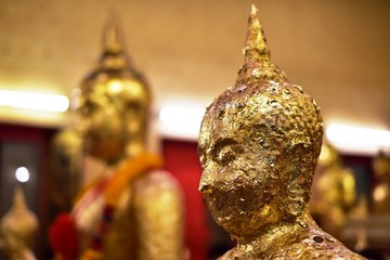 Golden statue of buddha in temple, Thailand	