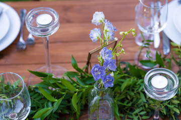 Preparing for an open-air party. Decorated with fresh flowers served tables. Table number. Decoration Details