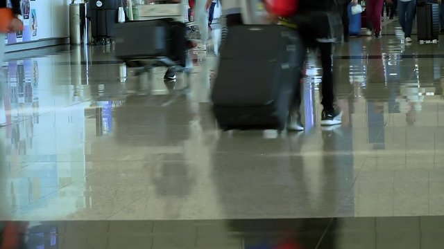 Time lapse of crowd of people walking with luggage in the international airport. Tourists In Hong Kong Airport Terminal.