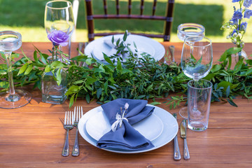 Preparing for an open-air party. Decorated with fresh flowers served tables. Table number. Decoration Details
