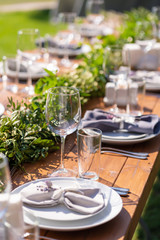 Preparing for an open-air party. Decorated with fresh flowers served tables. Table number. Decoration Details