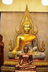 Golden statue of buddha in temple, Thailand	