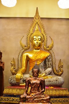 Golden statue of buddha in temple, Thailand	