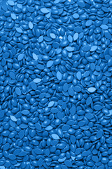 Bright colored granules. Abstract beautiful background. Granules for hair removal. Vivid colorful classic blue Wallpaper. Vibrant. Waxing wax. Spa salon banner, copy space