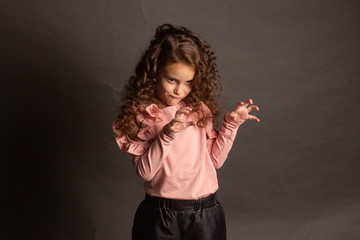 Studio portrait of a little girl with long curly hair