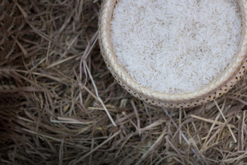 Rice in a container Lay on the ground of rice straw. Rice closeup. With space to place text