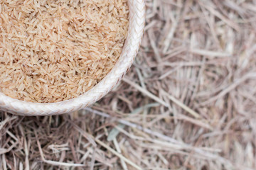 Rice in a container Lay on the ground of rice straw. Rice closeup. With space to place text