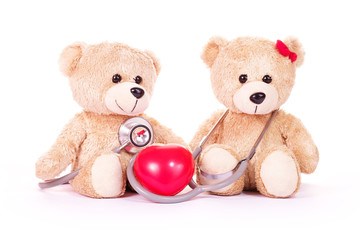Teddy bears, red heart and stethoscope with blackboard on a white background. Health concept.