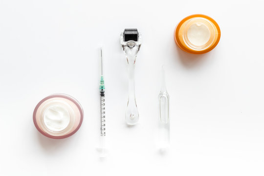 Dermatologist Work Desk With Tools. Dermaroller, Syringe, Ampoule On White Background Top-down Flat Lay Copy Space