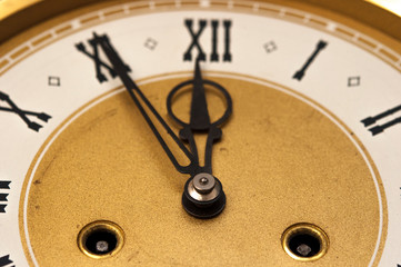 golden and white clock in front