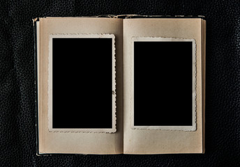 Photo blank. Open old book on black leather background