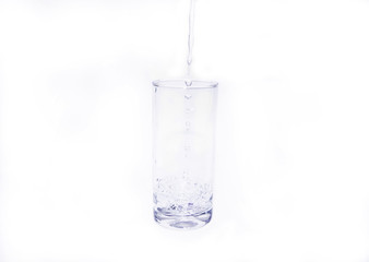 Pouring fresh healthy water into glass on white background.